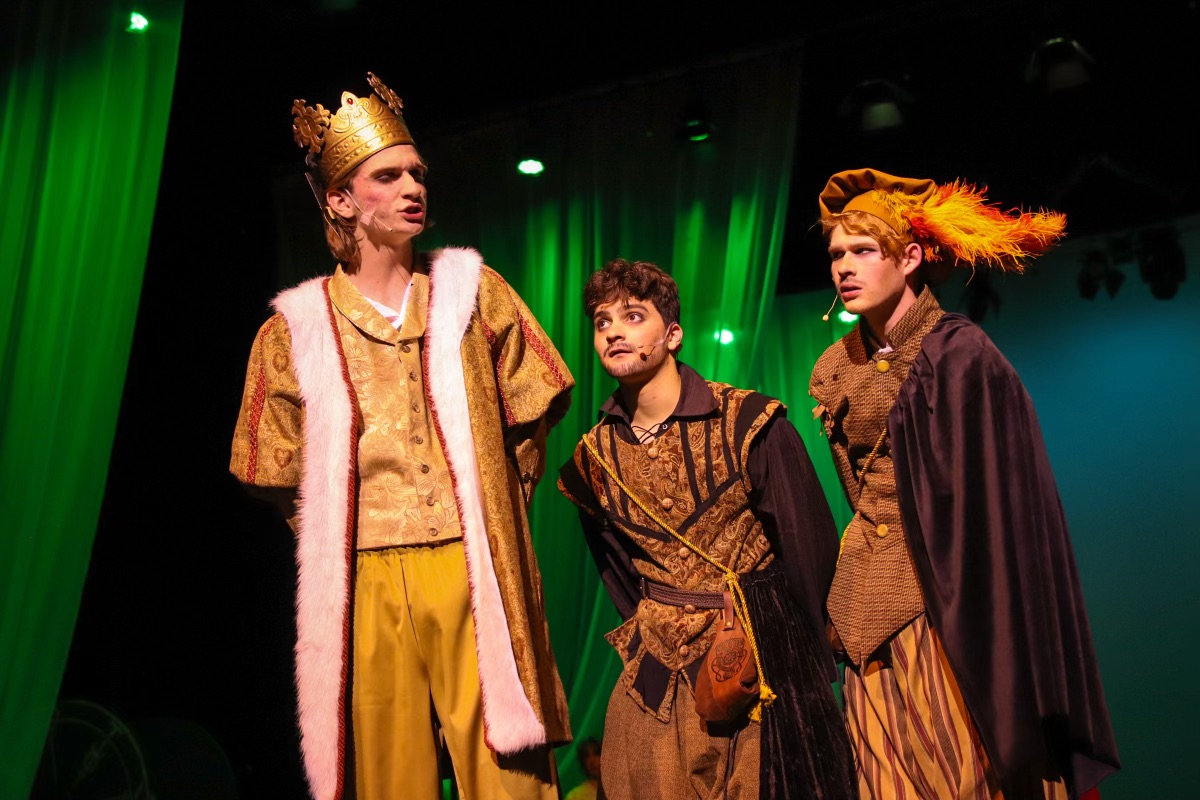 Rosencrantz (Jack Andersen, right) and Guildenstern (Xavier Lago, middle) follow King Claudius (Andrew Young, left).