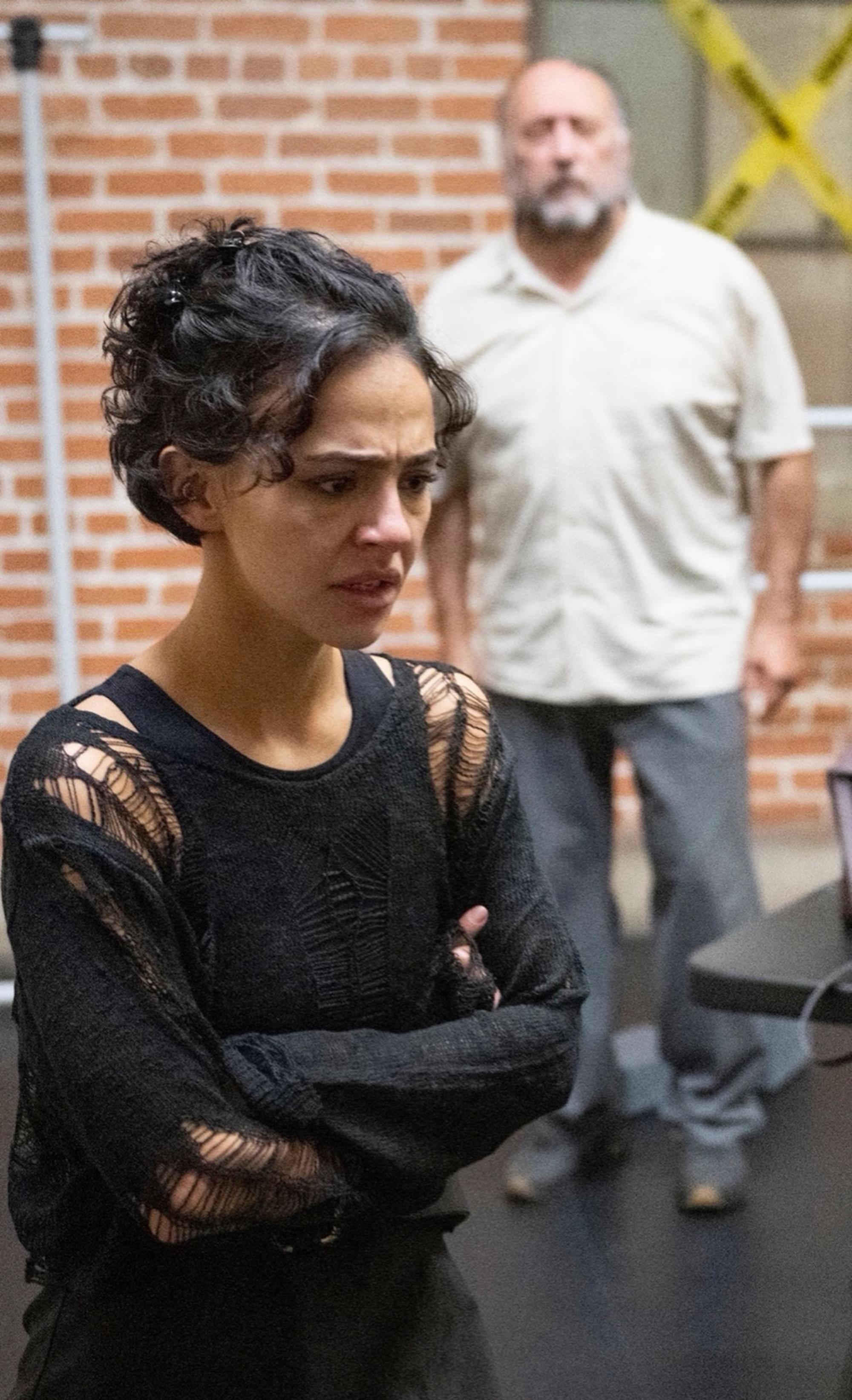 Una confronts the past as Ray watches from a distance in a tense moment from Blackbird. 