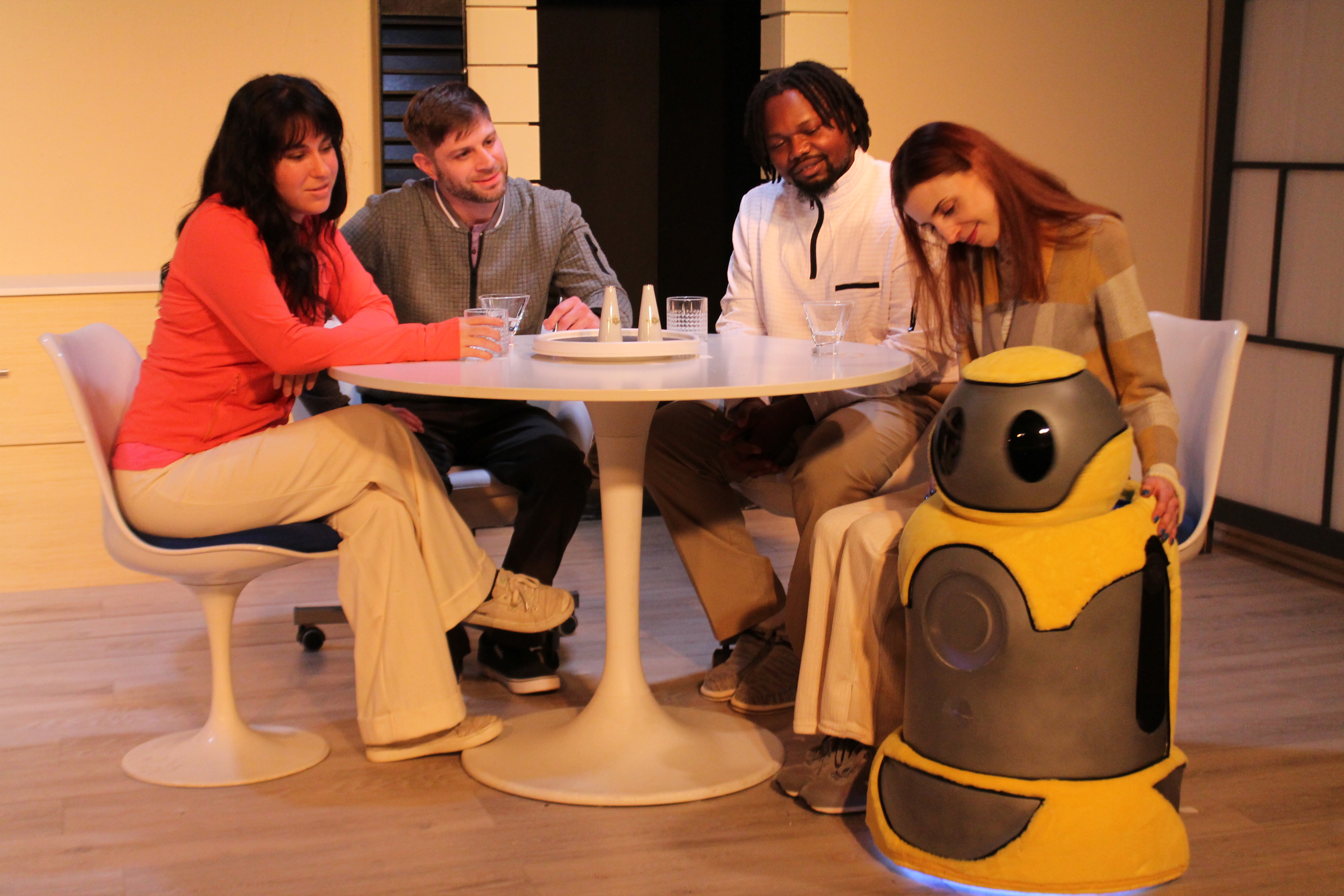 Carrie (Chloe Richter), Patrick (John Lopacki), Oliver (Jamil Long), and Anna (Caity Brown) all enjoying a friendly dinner with Arthur (Voiced by Scott Karlin and operated by Robert A. Norman).