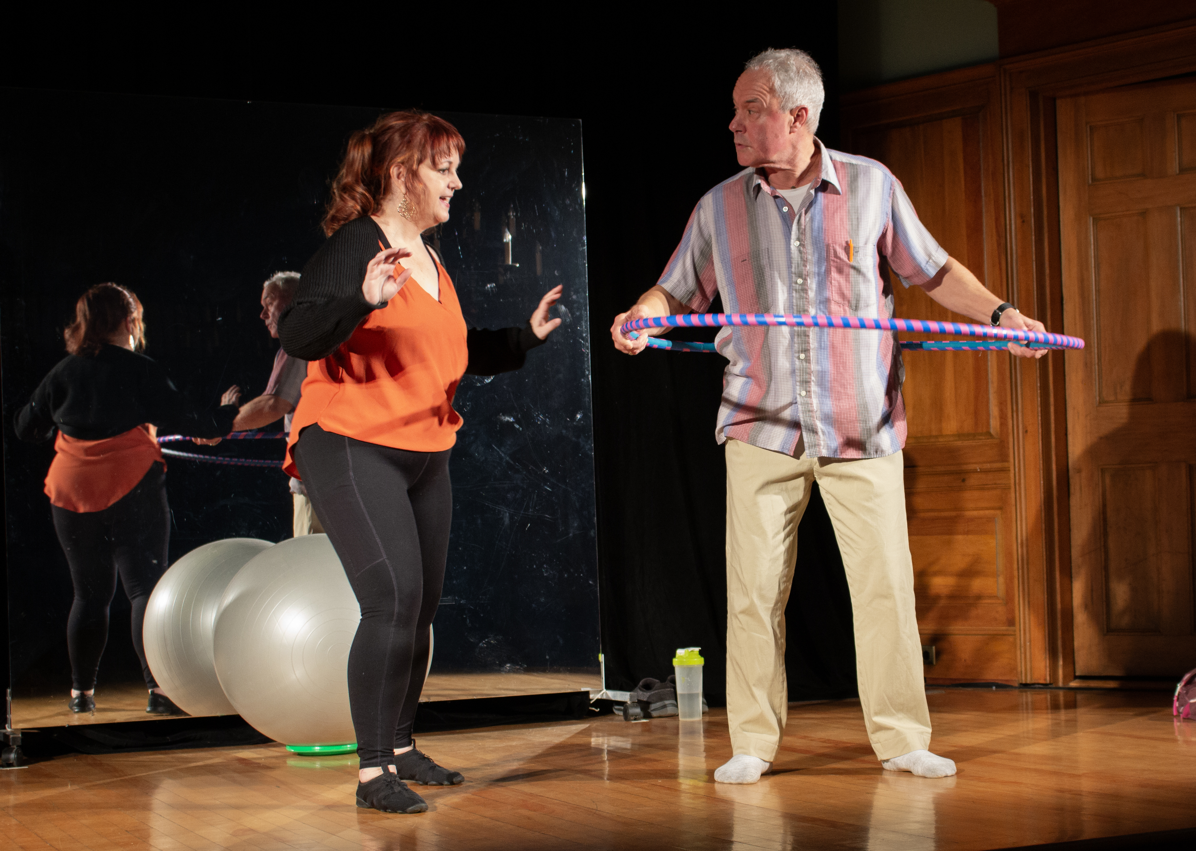 Theresa (Kym Taylor) teaches James (Ben Ash) how to hoop in Circle Mirror Transformation with The Shelburne Players.