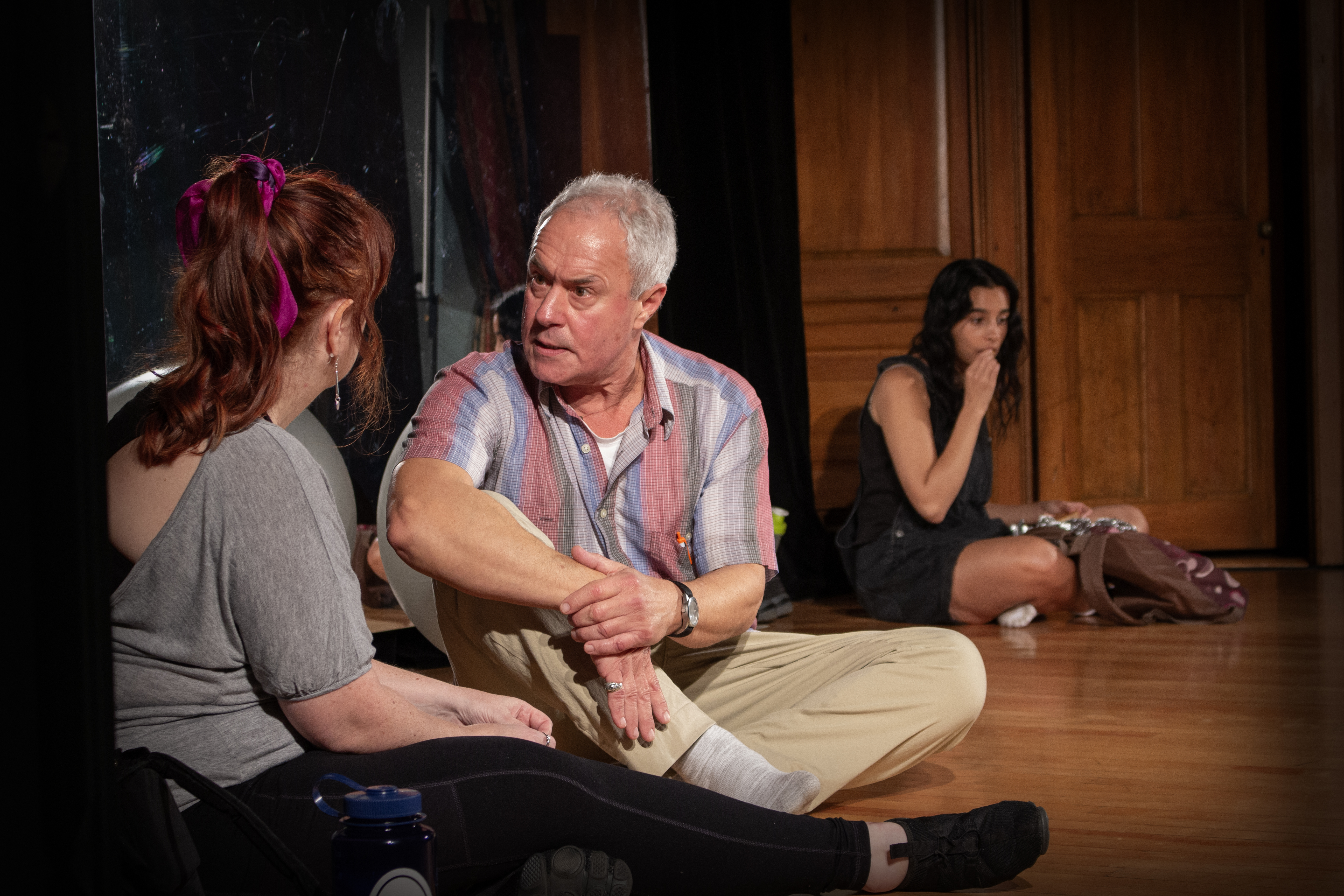 Lauren (Maya Grace Redington) eavesdrops on a conversation between Theresa (Kym Taylor) and James (Ben Ash) in Circle Mirror Transformation with The Shelburne Players.