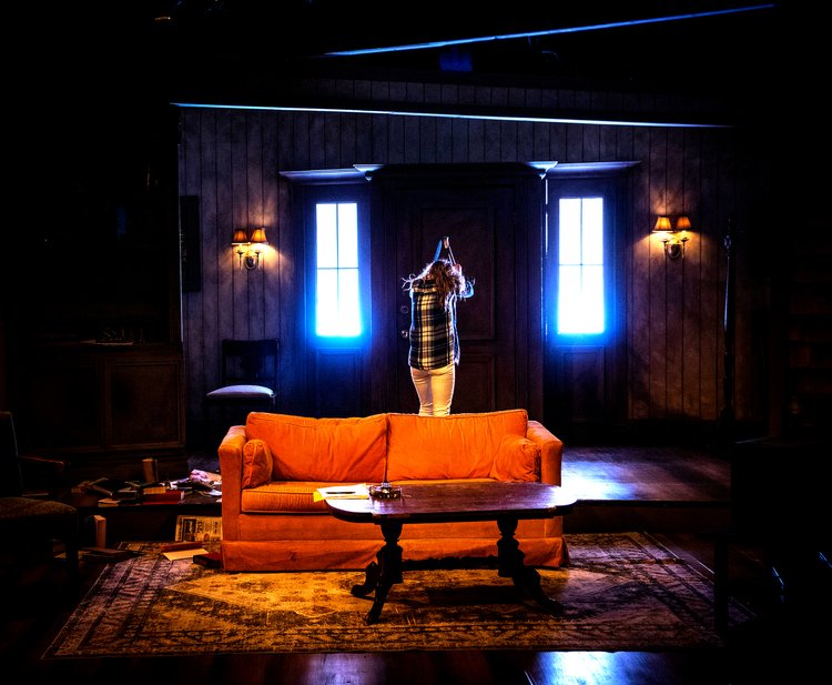 Grace (Leah Berst) in possessed living room.