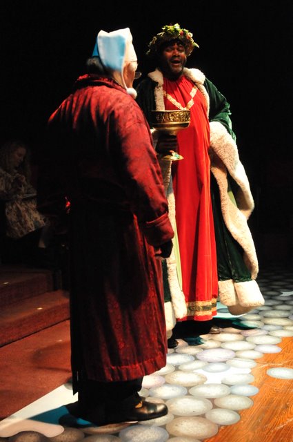 You Are Even More Awful Than My Brothers Said You Were: Darryl Maximilian Robinson as The Ghost of Christmas Present meets Mario Di Gregorio as Ebenezer Scrooge in A Christmas Carol.