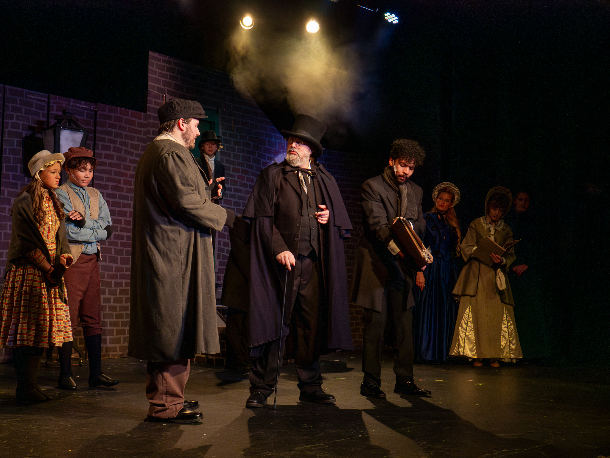 L TO R: Caroline V. as Ensemble, Teo P. as Ensemble, Andrew Neal as Ensemble, Darrell Meek as Scrooge, Christian No l as Bob Cratchitt.