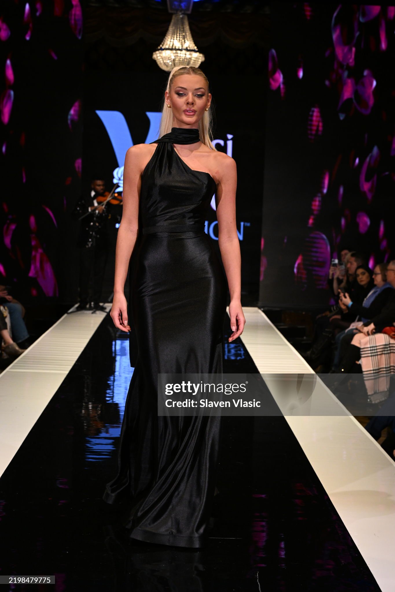 HiTechMODA Productions NYFW Season 13 - Yesi Rose Fashion NEW YORK, NEW YORK - FEBRUARY 08: Violinist Dr. Edward W. Hardy performs on stage while a model (Miss Universe-Victoria Kj r Theilvig) walks HiTechMODA Productions NYFW Season 13 - Yesi Rose Fashion NEW YORK, NEW YORK - FEBRUARY 08: Violinist Dr. Edward W. Hardy performs on stage while a model (Miss Universe-Victoria Kj r Theilvig) walks