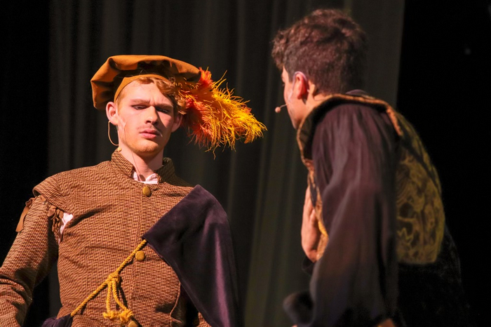 Rosencrantz (Jack Andersen) observes a coin. 3