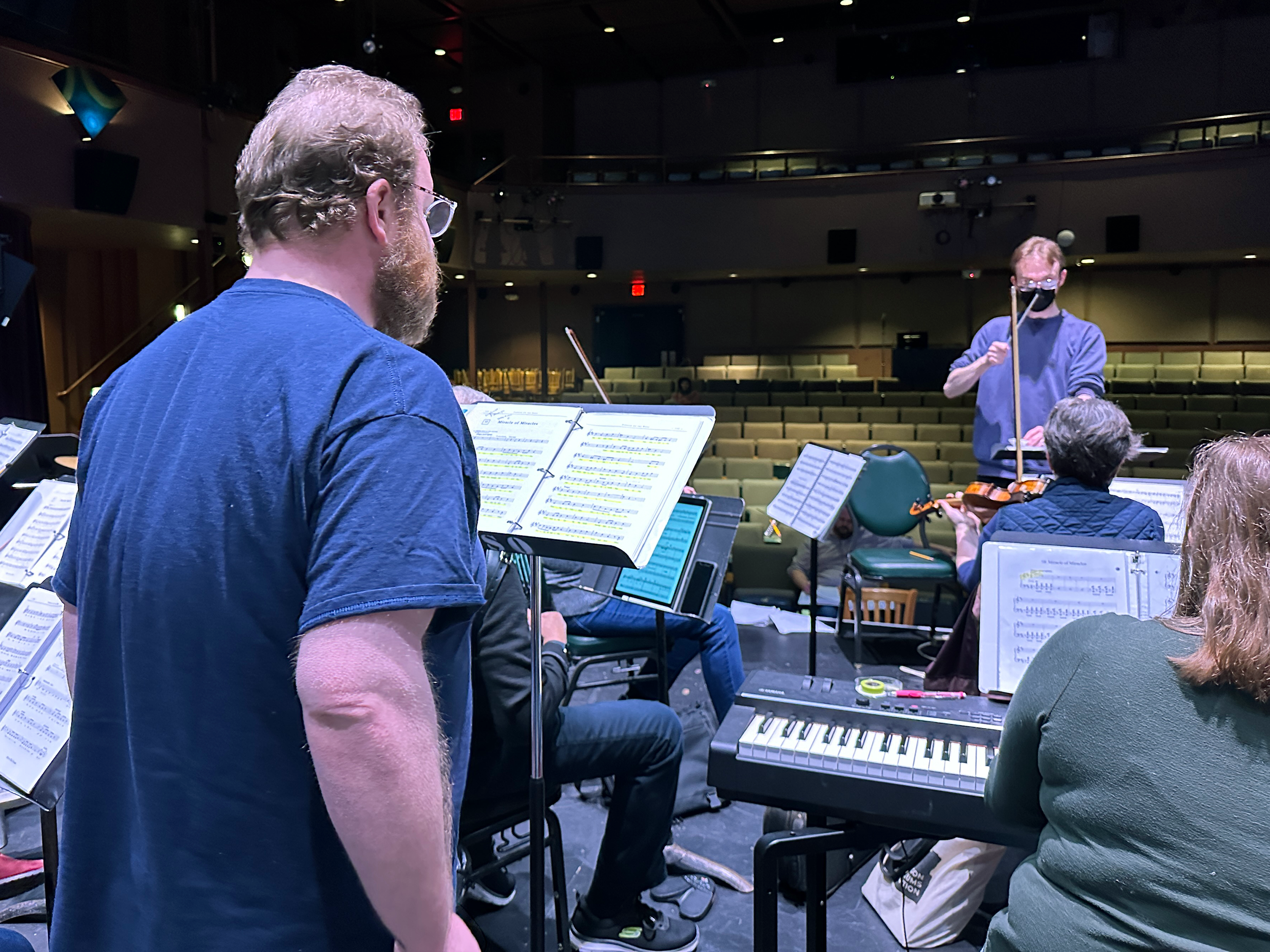 Cody Larsen (Motel) rehearses with the orchestra, conducted by Milo Graamans.