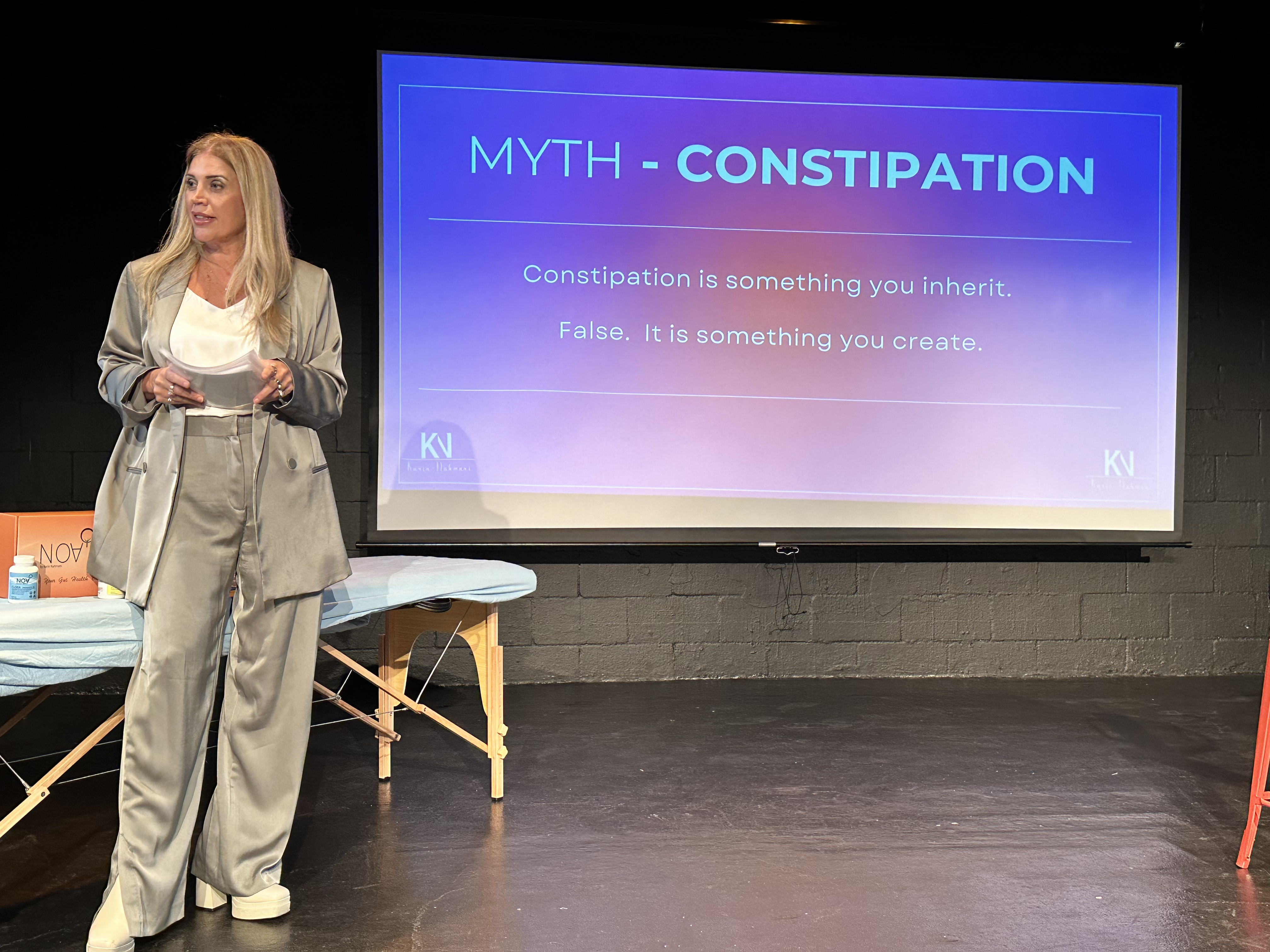 Karin Nahmani on stage talking about one of her favorite subjects during her one-woman show