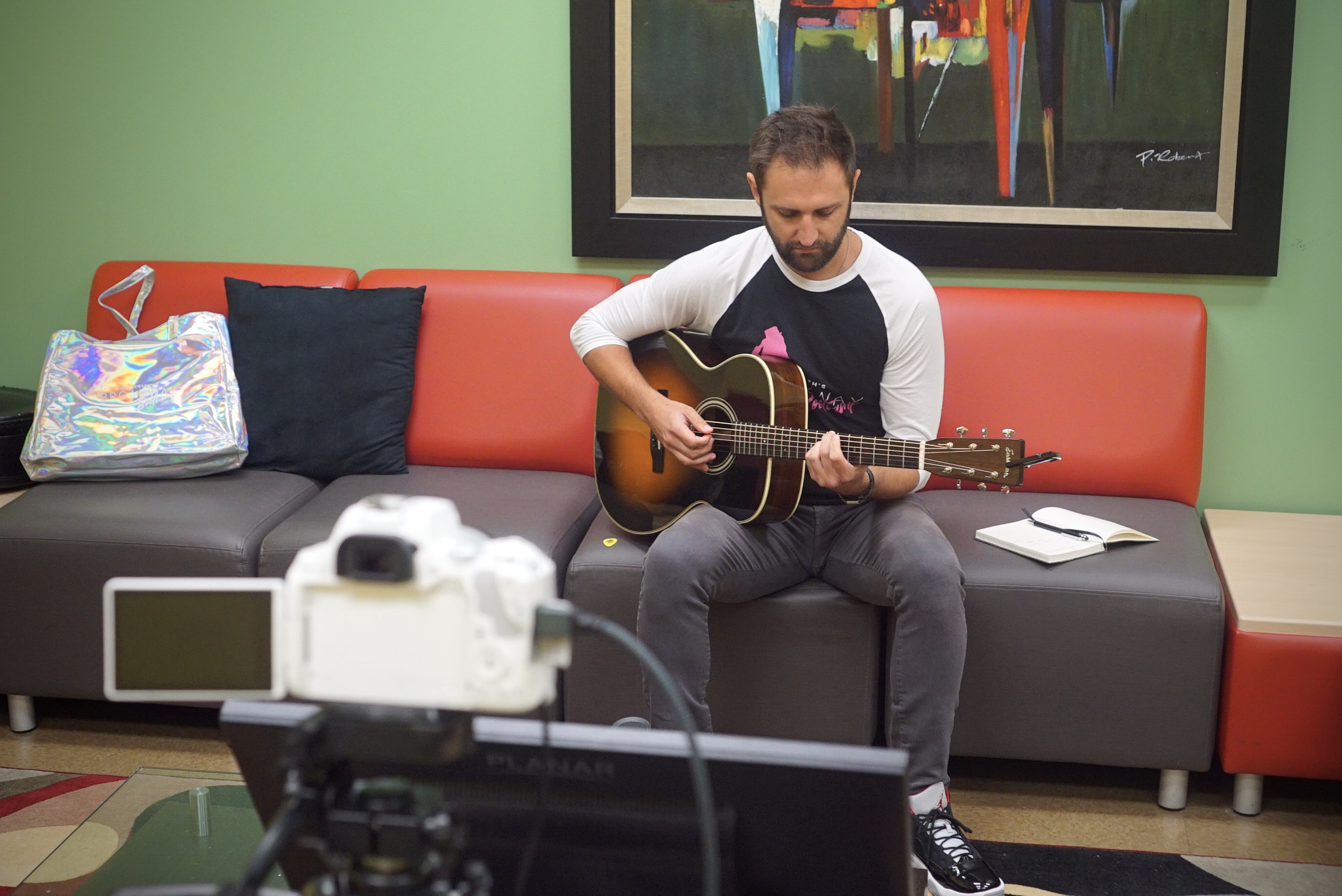 Josh Bryant warms up before leading songwriting class at camp. Photo Credit: Merrill Mitchell