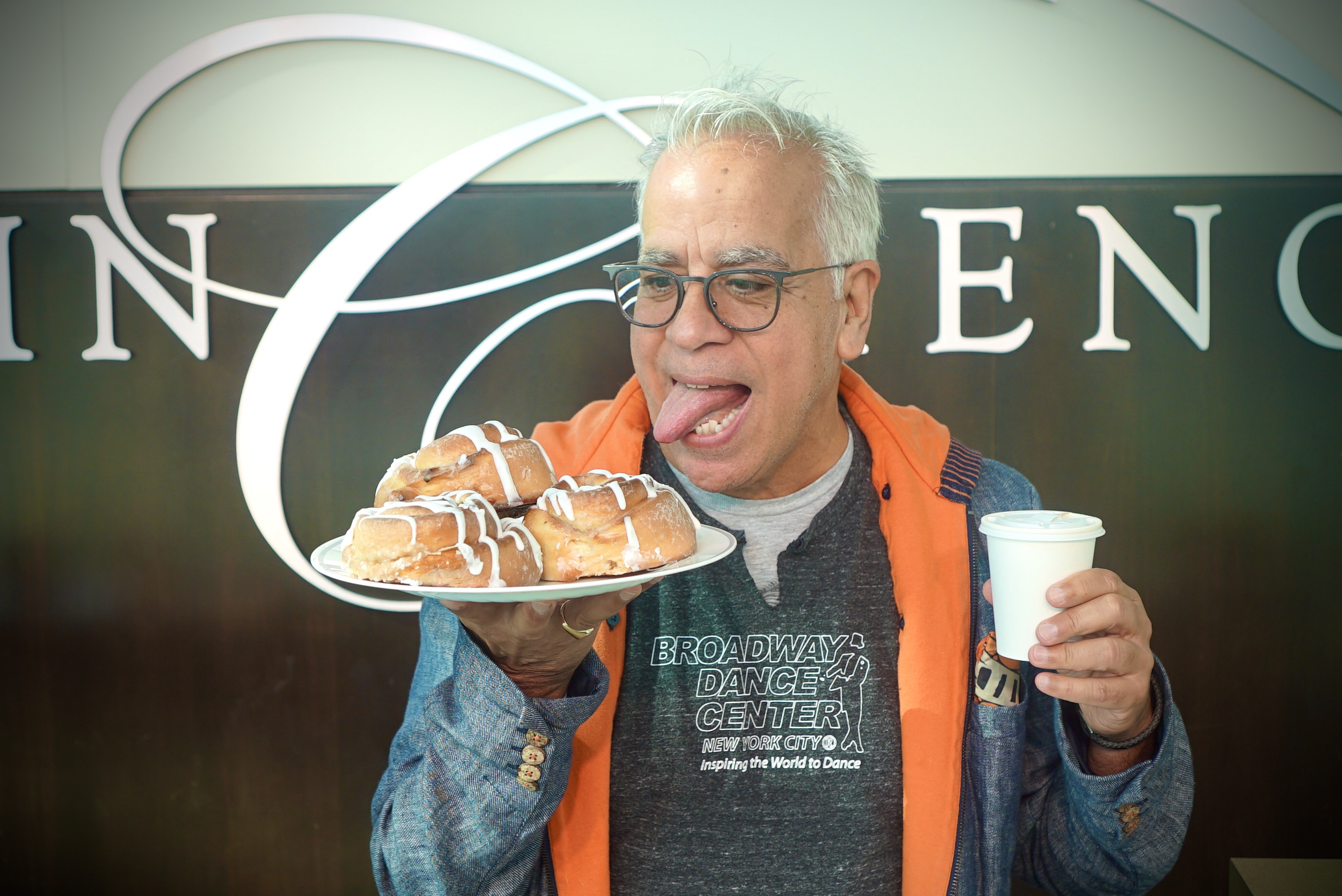 Good Morning Campers! Camp director Richard Jay-Alexander enjoys cinnamon rolls before opening the morning show. Photo Credit: Merrill Mitchell