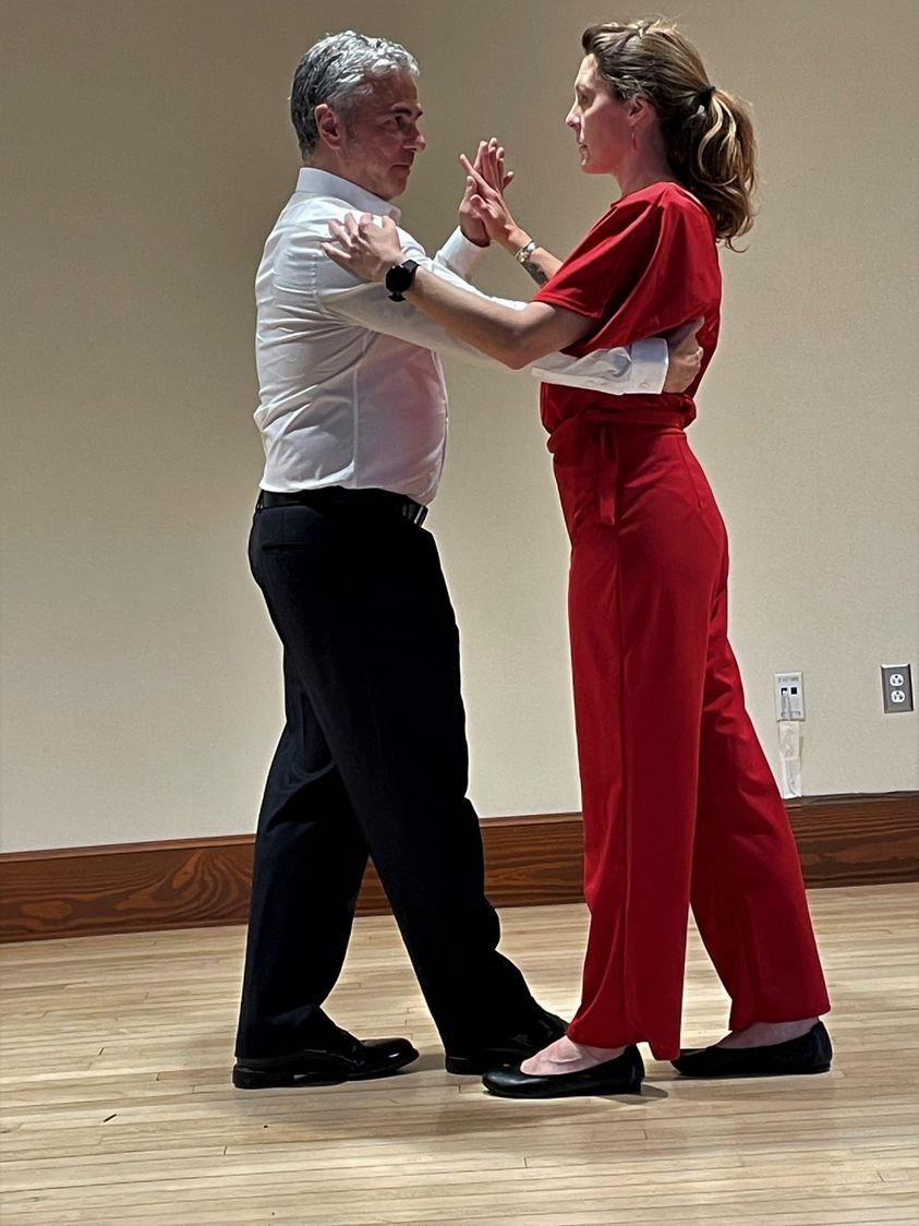 Joan (Kenzie Yelin) gets a tango lesson from NYC fire captain Nick (Mark DiPietro) 