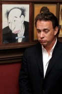 Tom Hanks poses in front of a caricature Photo