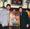 A beaming Alfred posing with his painting along with Dale Badway Photo