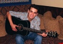 
Michael Longoria poses with his guitar  Photo