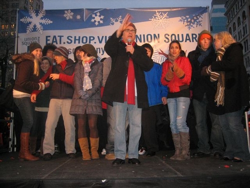 Paul Kreppel (center) led the casts in a holiday carol Photo