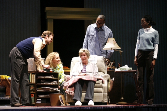 BRENDA WEHLE as Ann Kron (in chair) surrounded by the ENSEMBLE (Photo by Jon Gardiner Photo