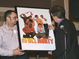 George Dvorsky signs The Full Monty poster for the live auction while former employee Photo