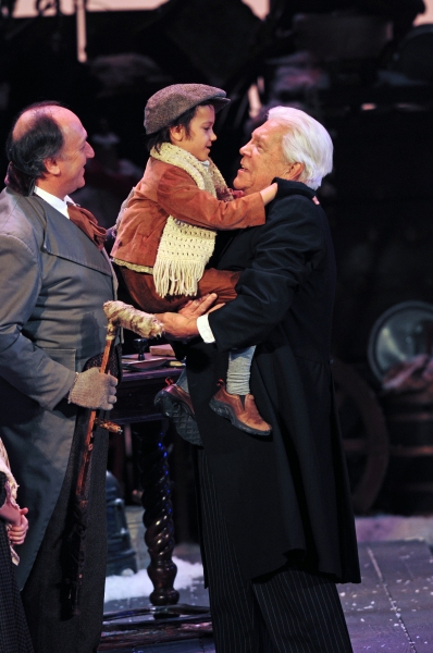 Jeffrey Howell as Bob Cratchit, Simon Nigam as Tiny Tim and Tom Atkins as Scrooge Photo