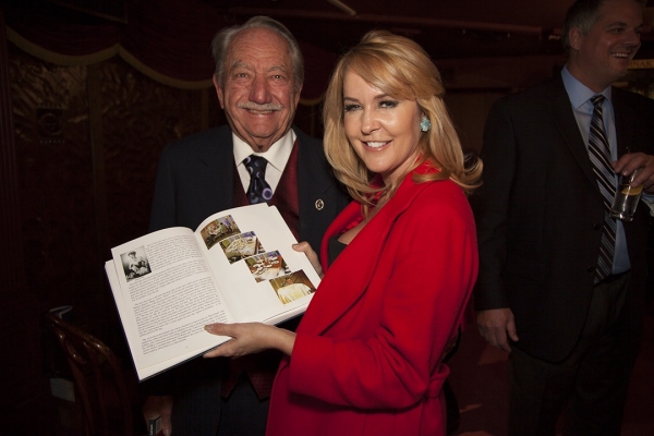 Milt Larsen shows a member of magic royalty, Erin Murphy, her place in his book as Ta Photo