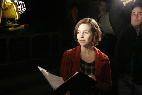 The cast illuminates Jessica Grove in a scene from the show. Photo credit: Michael Bo Photo