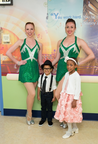 The Rockettes with Garden of Dreams children Malik Naser and Julianna Pierre check ou Photo