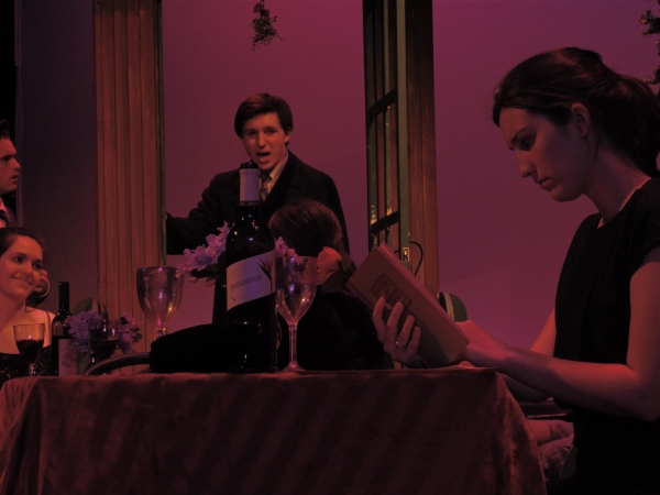 Sipos (Tommy Prast) peeks in at Amalia (Holly Linneman), who waits to meet her lonely Photo