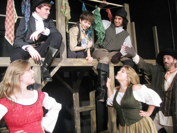 Fagin (DeLarme Landes, far right) introduces Oliver (Adam Juraga, center) to Nancy (T Photo