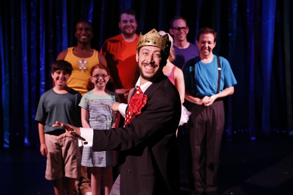 King Edward the Sensible (Jason Pintar) leads a chorus singing about the Kingdom of A Photo