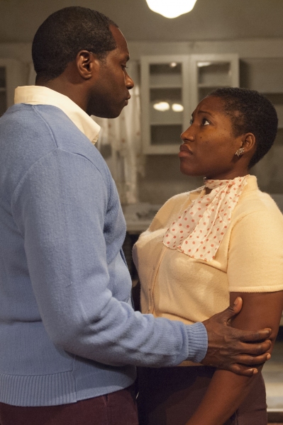 Joseph Asagai (Daryl Satcher, left) gives Beneatha Younger (Mildred Marie Langford) m Photo