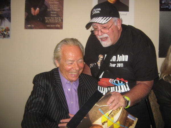 Richard Georgeou of Hudson, New Hampshire, gets an autograph from drummer Nigel Olsso Photo