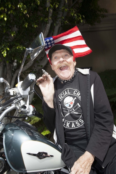 Comedian, Rip Taylor, signs the bike Photo