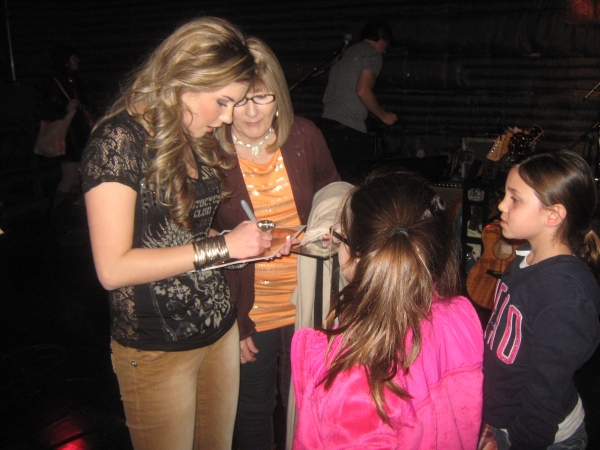 Singer Kaitlyn Baker signs autographs, following performance Photo