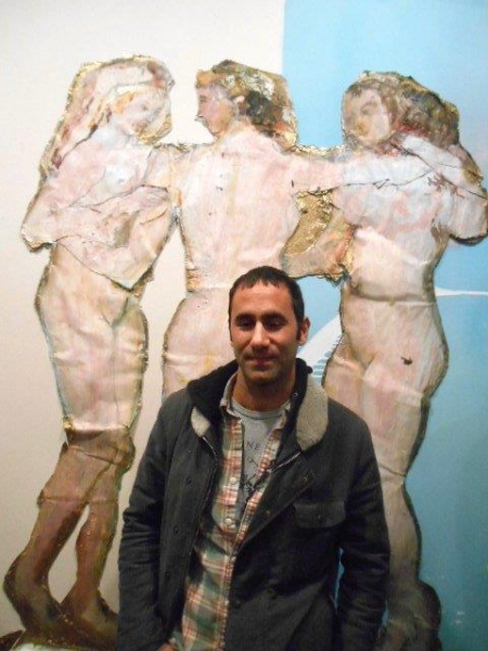Artist Darius Yektai in front of his painting, Three Graces Photo