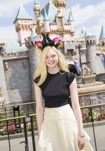 Elle Fanning poses at Sleeping Beauty Castle at Disneyland Photo