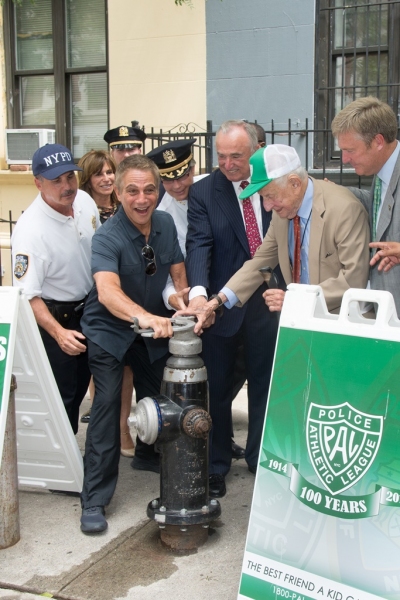 New PAL Board Member Tony Danza opens a fire hydrant for NYC youth to cool off under  Photo