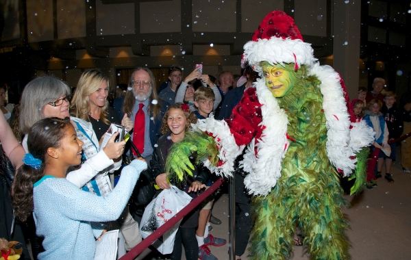The Grinch (Burke Moses) greets audience members Photo