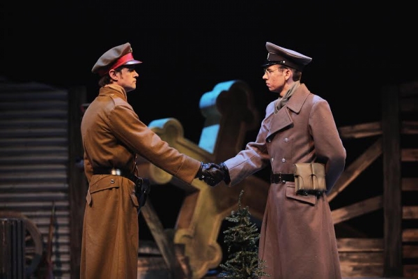 A British officer reluctantly shakes hands with his German counterpart. Left to right Photo