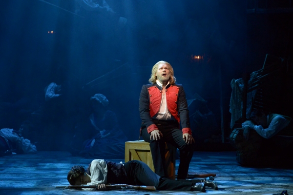 Valjean (Gregg Goodbrod) sings as Marius (Joshua Charles Skurnik) sleeps Photo