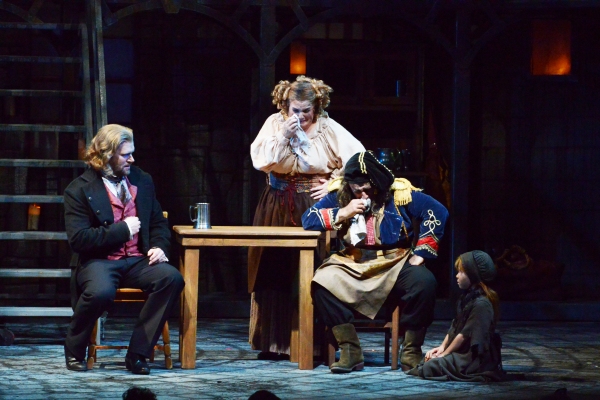 Valjean (Gregg Goodbrod), left, consults with Mme. Thenardier (Margot Moreland) and T Photo