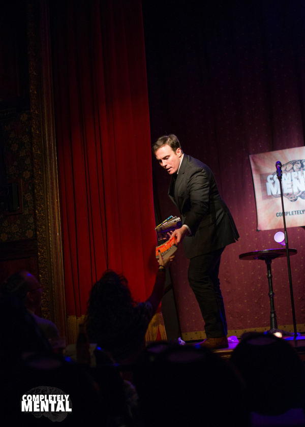 Mentalist and magician Patrick Terry prepares an audience member for something that i Photo