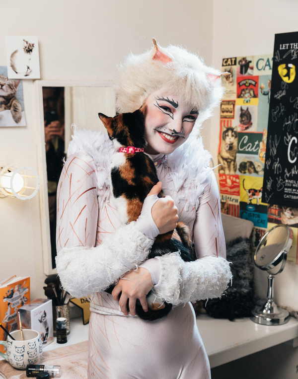 Claire Rathbun of the CATS cast shares a hug backstage with a shelter kitten Photo