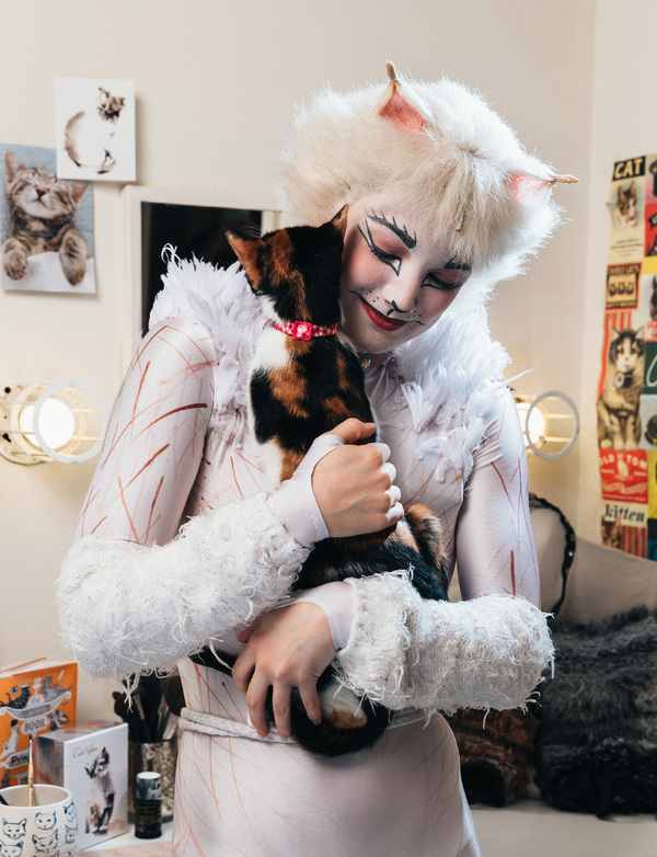 Claire Rathbun of the CATS cast shares a hug backstage with a shelter kitten Photo