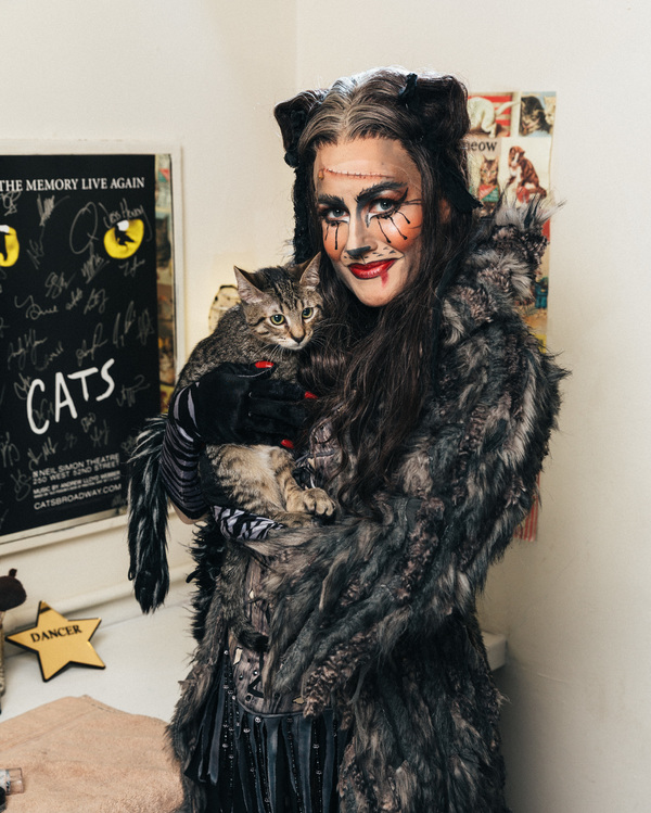 Mamie Parris of the CATS cast and an adoptable shelter cat share a moment backstage Photo