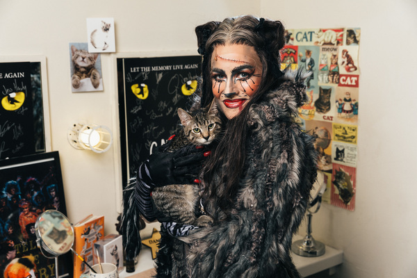 Mamie Parris of the CATS cast and an adoptable shelter cat share a moment backstage Photo