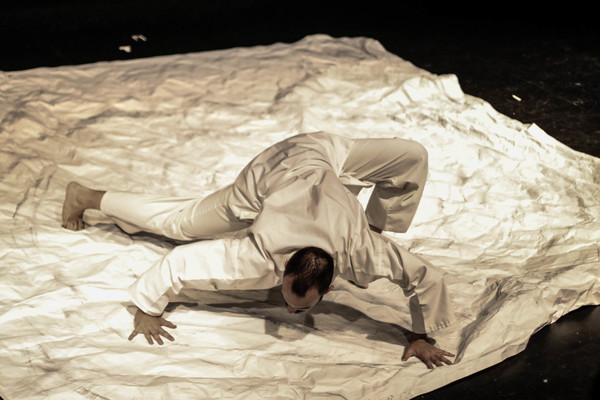 Origami artist and performer Sam Robbins as the "Paper God." Photo by Thomas Wilson @ Photo