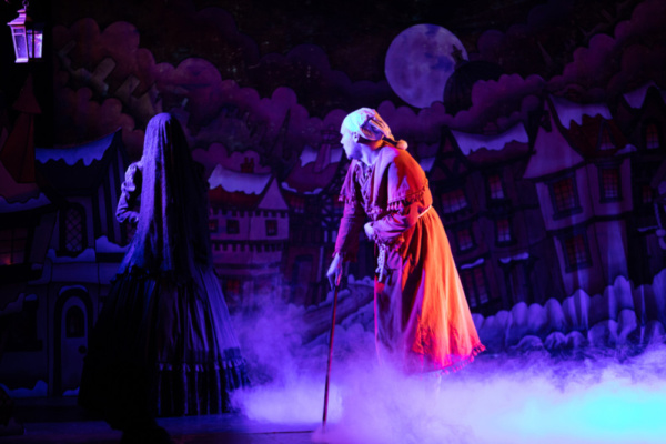 Scrooge (Eric Fletcher) and the Ghost of Christmas Yet to Come (Courtney Hansen)

Pho Photo