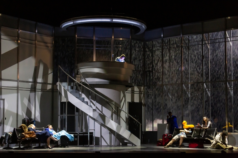 R. Keith Brumley's set design for the opera Flight, which depicts a darkened airport terminal with lightning flashing outside its windows as passengers sleep