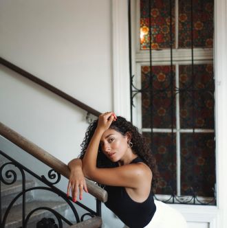 Soprano Andrea Carroll posing in profile on staircase