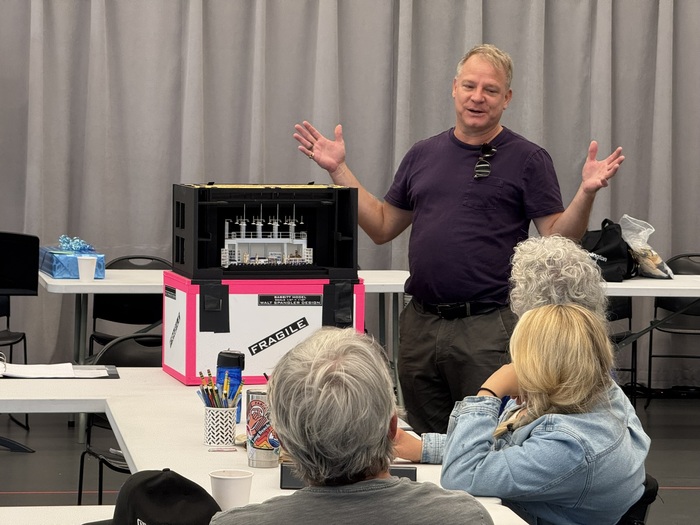 Scenic designer Walt Spangler shares the set of Babbitt with the cast and creative te Photo