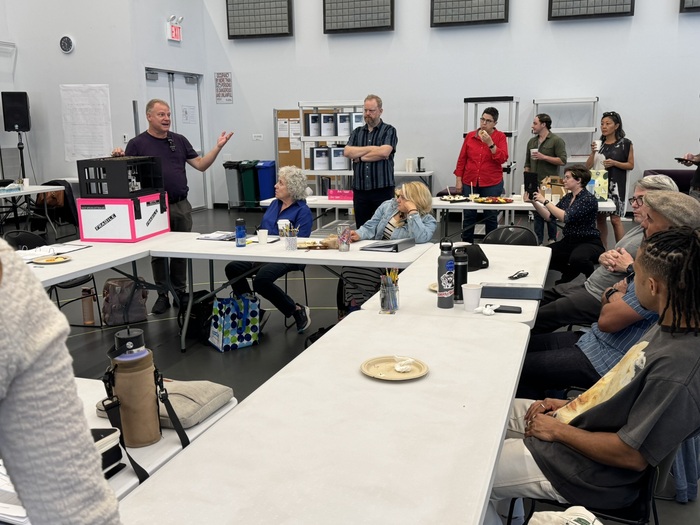 Scenic designer Walt Spangler shares the set of Babbitt with the cast and creative te Photo